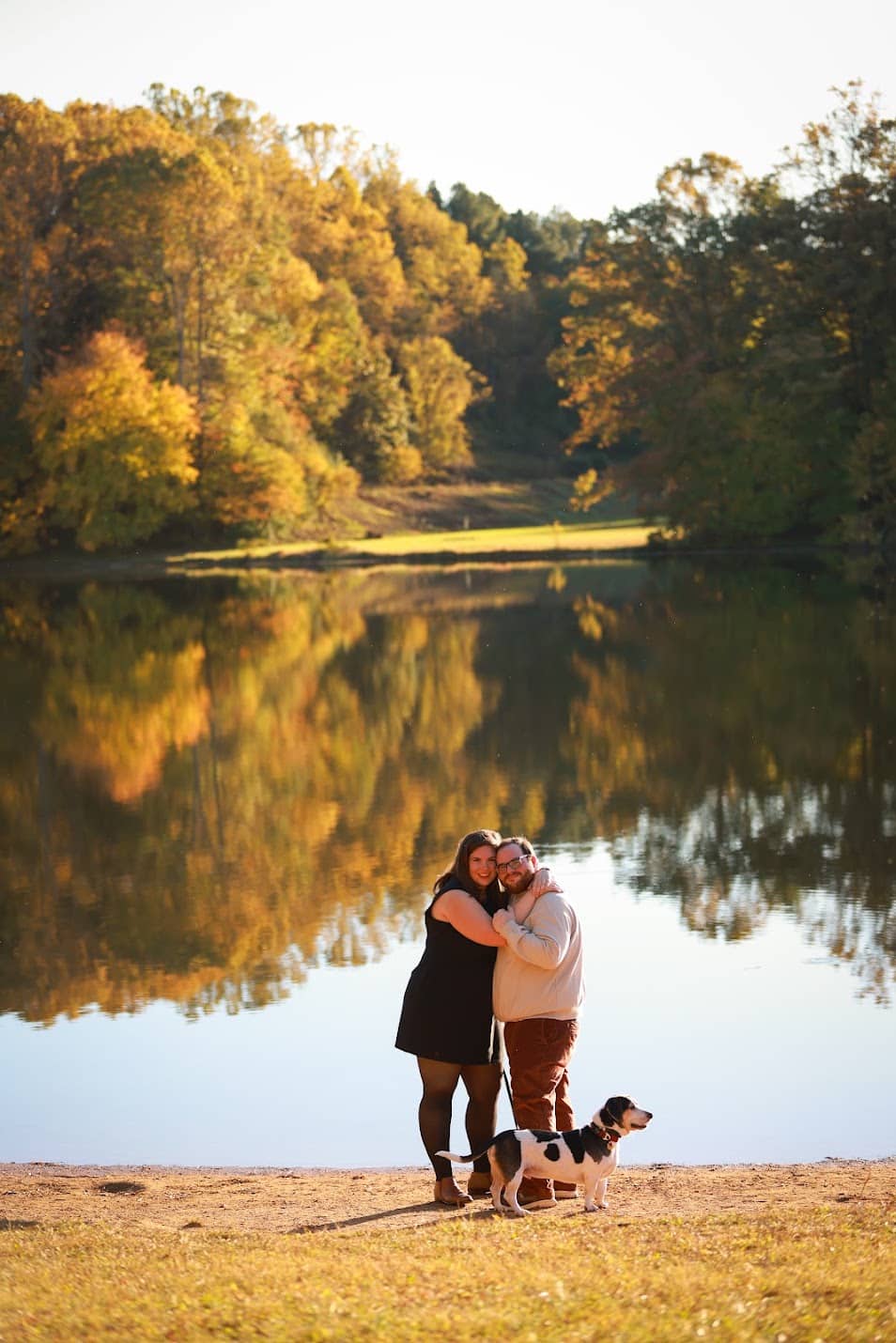 Lois, Ethan, and a dog at a lake.